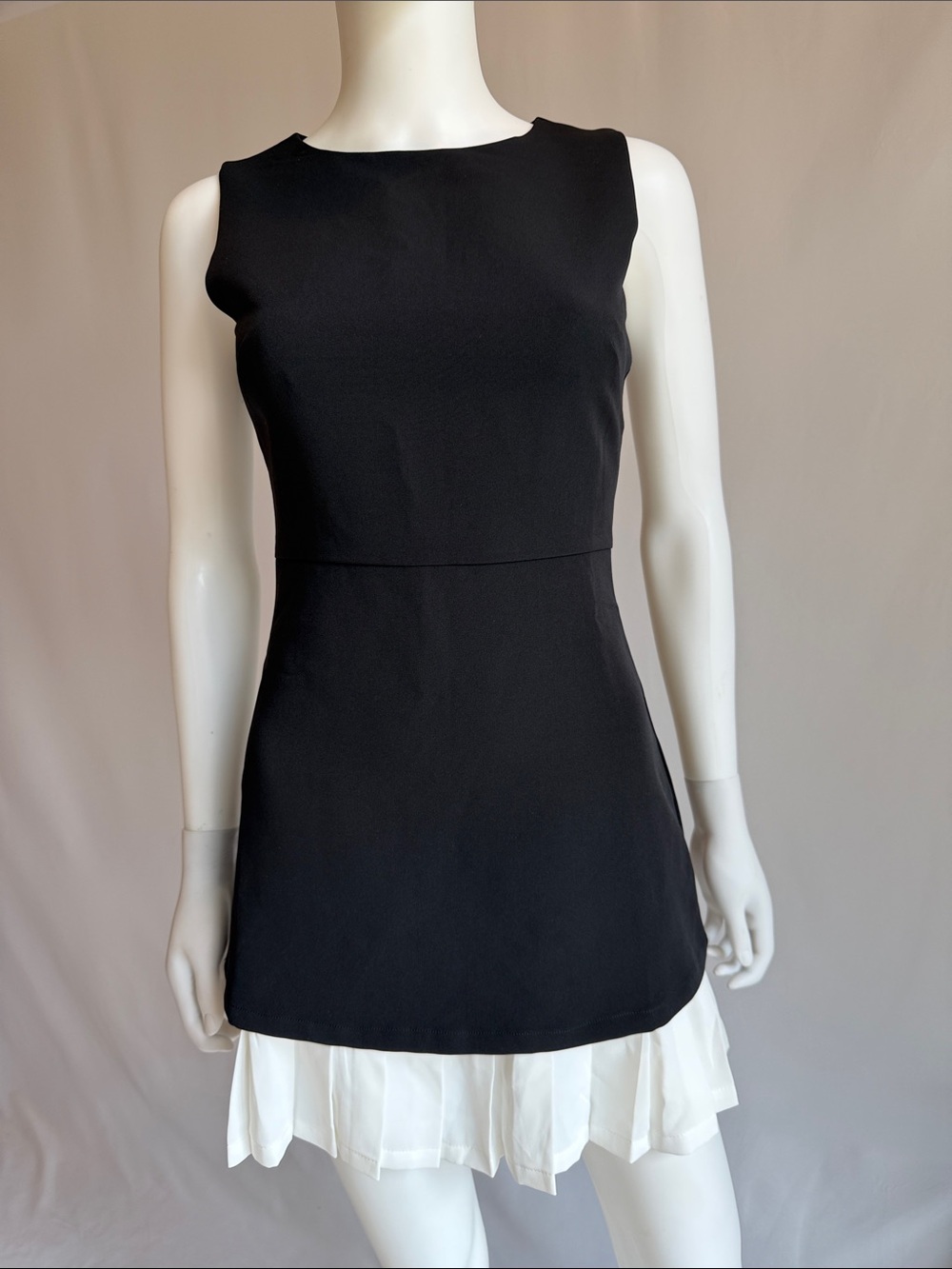 Commense Black Sleeveless Shift Dress with White Pleated Hemline